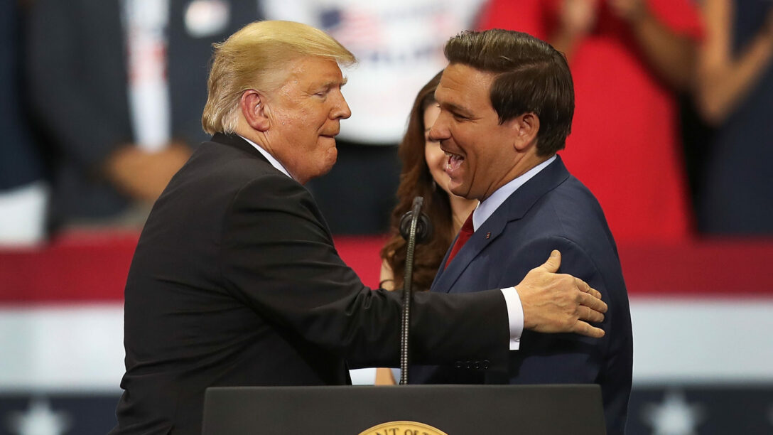 President Donald Trump greets Ron DeSantis during a campaign rally in 2018.
