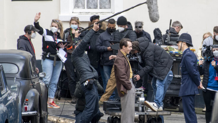 David Dawson and Harry Styles filming the My Policeman with a masked crew in the background