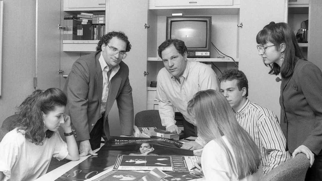 Harvey Weinstein and his brother Bob Weinstein conferring with staff in the NYC Miramax office in 1989