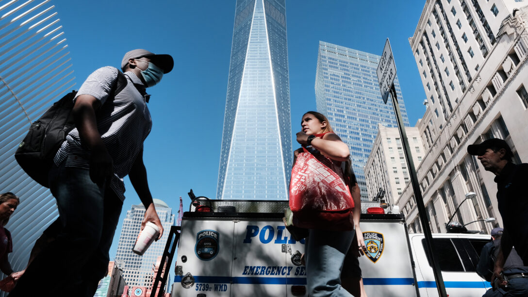 People walk by One World Trade Center in lower Manhattan