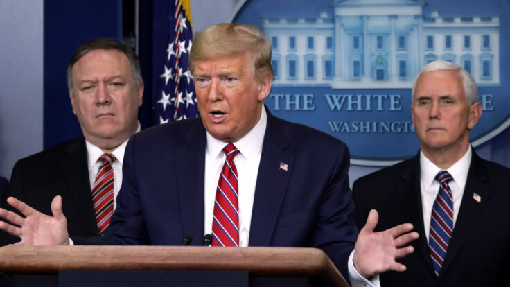 Mike Pompeo and Mike Pence flank Donald Trump