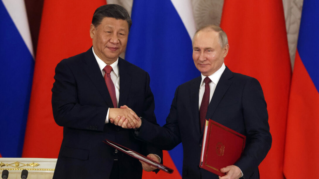 Chinese President Xi Jinping and Russian President Vladimir Putin shake hands during the signing ceremony at the Grand Kremlin Palace.