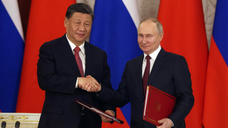 Chinese President Xi Jinping and Russian President Vladimir Putin shake hands during the signing ceremony at the Grand Kremlin Palace.