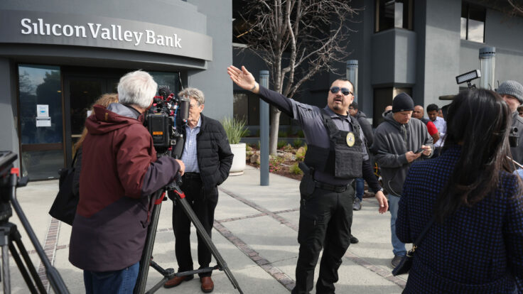 A scrum of security guards, reporters, and customers outside of Silicon Valley Bank a few days after it collapsed.