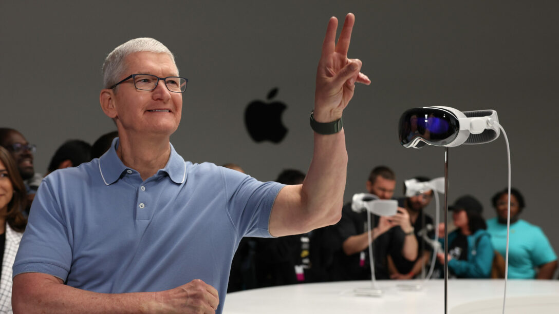 Apple C.E.O. Tim Cook stands next to the new Apple Vision Pro headset.