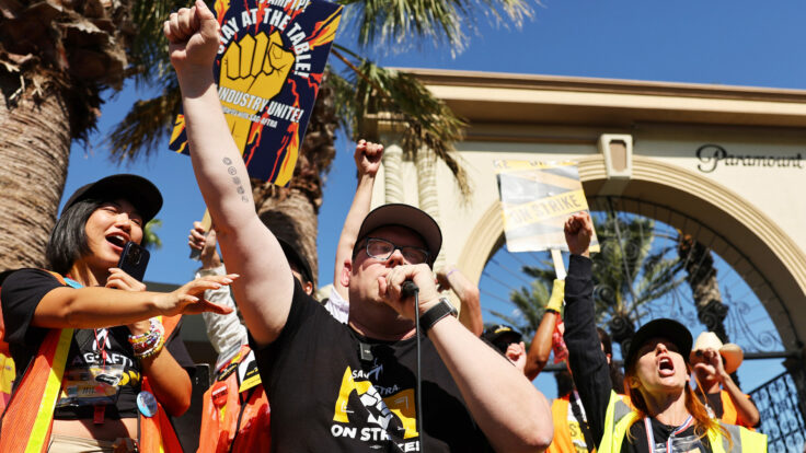 SAG-AFTRA National Executive Director and chief negotiator Duncan Crabtree-Ireland (C) raises his fist while speaking at the conclusion of picketing outside Paramount Studios on day 113 of their strike against the Hollywood studios on November 3, 2023, in Los Angeles, California.