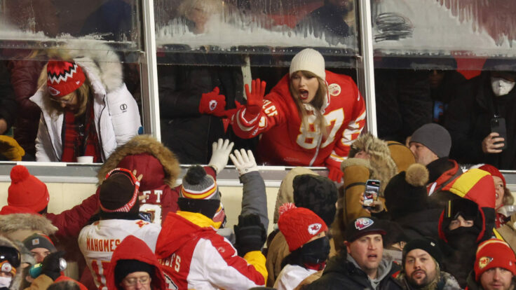 Taylor Swift celebrates with fans during the AFC Wild Card Playoffs between the Miami Dolphins and the Kansas City Chiefs at GEHA Field at Arrowhead Stadium on January 13, 2024 in Kansas City, Missouri.