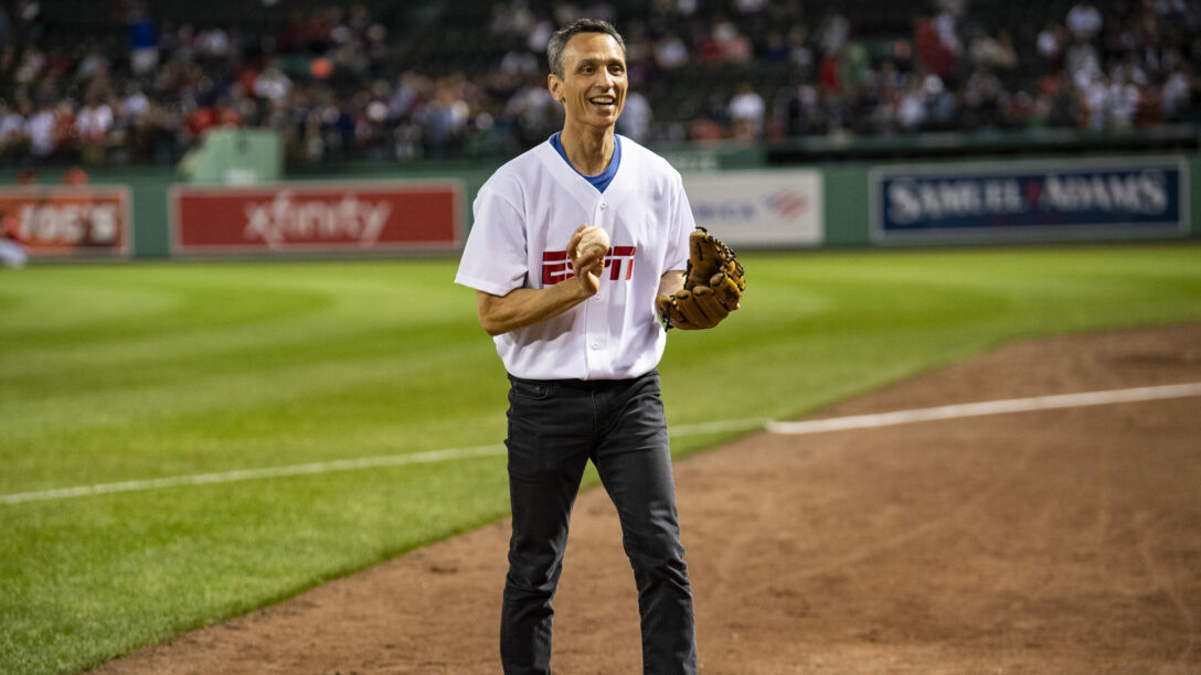 ESPN President Jimmy Pitaro warms up before catching a ceremonial first pitch before a game between the Boston Red Sox and the New York Yankees at Fenway Park in Boston