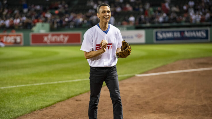 ESPN President Jimmy Pitaro warms up before catching a ceremonial first pitch before a game between the Boston Red Sox and the New York Yankees at Fenway Park in Boston