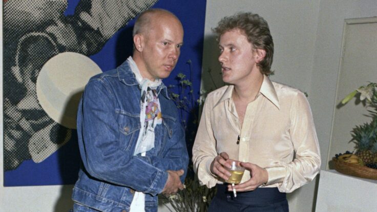 Artist Ray Johnston and Michael Findlay at a party in honor of David Hockney, held in Findlay’s New York City loft apartment.